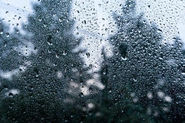 Water drops on a glass.  Heavy rain on a window.  Unstable time.  Winter storms.  Macro photo of drops of water.