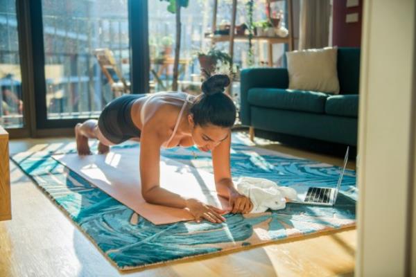 Young sporty woman practicing at home
