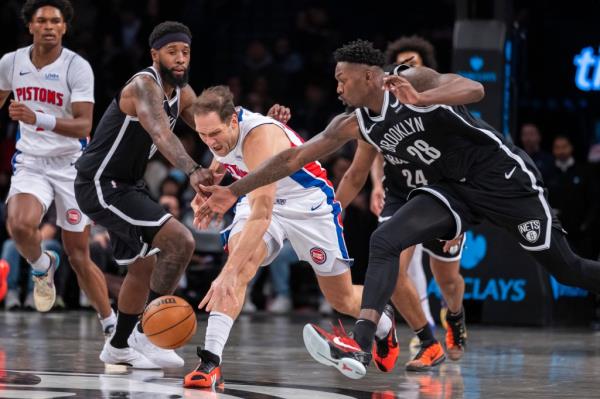  Nets forward Royce O'Neale (00) and forward Dorian Finney-Smith (28) fight for a ball with Detroit Pistons forward Bojan Bogdanovic (44) in the first half at Barclays Center, Saturday, Dec. 23