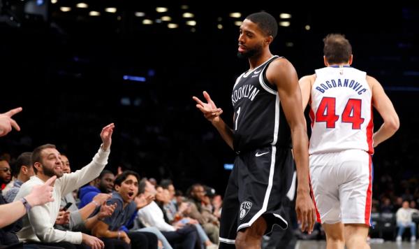 Nets forward Mikal Bridges (1) reacts after making a 3-point shot against Detroit Pistons forward Bojan Bogdanovic (44) during the first half of an NBA basketball game Saturday, Dec. 23,.