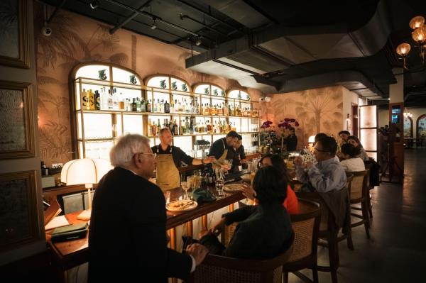 Patrons sit at the bar area in Bungalow