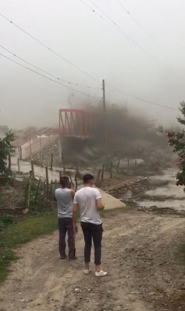 As the bridge came down, muddy waters rose on the walkways leading to the river.