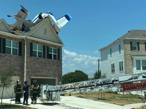 Firefighters at the scene of wher<em></em>e a small plane crashed into a home in Georgetown, Texas on July 23, 2023.