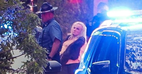 A suspect wearing a blond wig is arrested in co<em></em>nnection with a stabbing that wounded four girls in an AMC movie theater south of Boston Saturday, May 25, 2024. 
