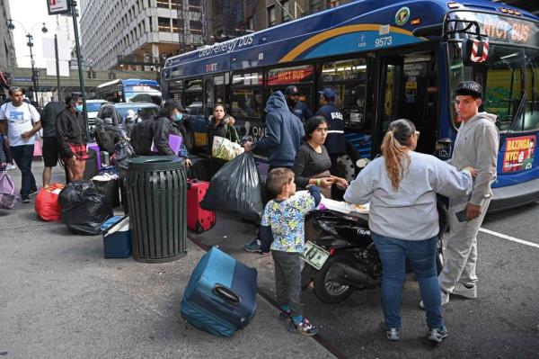 Migrants are seen arriving at the Roosevelt Hotel after a bus transported them from Saint John Villa Academy on Staten Island to Manhattan