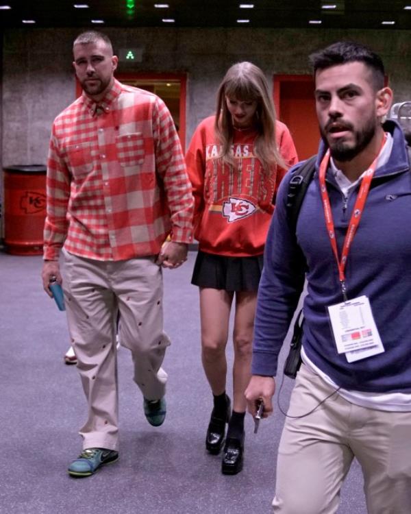 Kansas City Chiefs tight end Travis Kelce, left, and singer Taylor Swift leave Arrowhead stadium after an NFL football game between the Chiefs and the Los Angeles Chargers, Sunday, Oct. 22, 2023