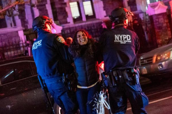Police officers arresting a woman during pro-Palestinian demo<em></em>nstrations at The City College of New York
