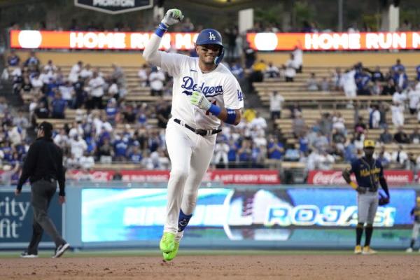 Los Angeles Dodgers' Miguel Rojas celebrates as he rounds third after hitting a solo home run during the second inning of a ba<em></em>seball game against the Milwaukee Brewers Wednesday, Aug. 16, 2023, in Los Angeles. (AP Photo/Mark J. Terrill)