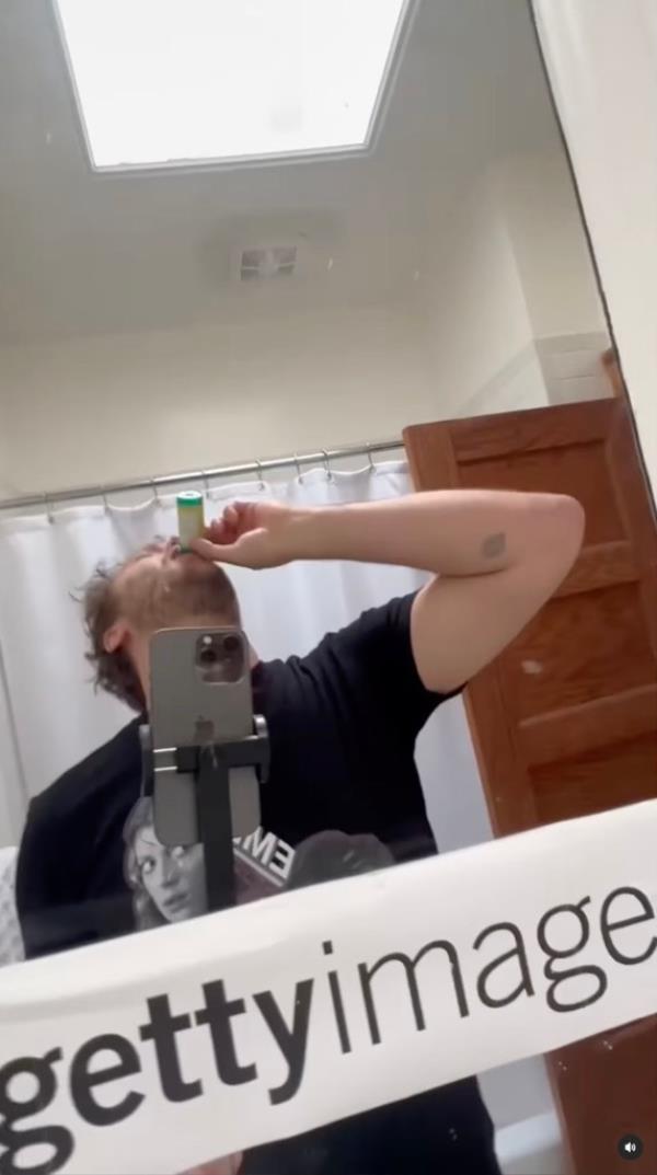 Robbins then cuts to himself brushing his teeth with a printed-out Getty Images label taped to his mirror. 