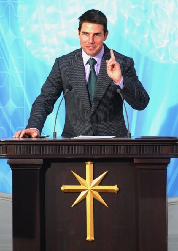 Tom Cruise at a podium talking for Scientology. 