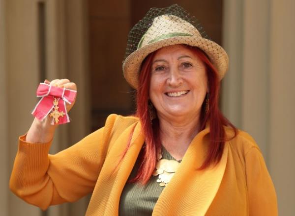 English businesswoman and campaigner Lynne Franks poses with her medal after being appointed Officer of the Order of the British Empire (OBE) at an investiture ceremony at Buckingham Palace in Lo<em></em>ndon on June 6, 2018.