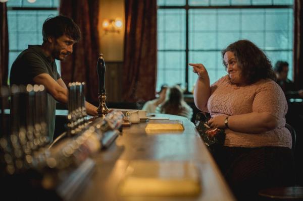 Richard Gadd and Jessica Gunning talking across a bar in a scene from 