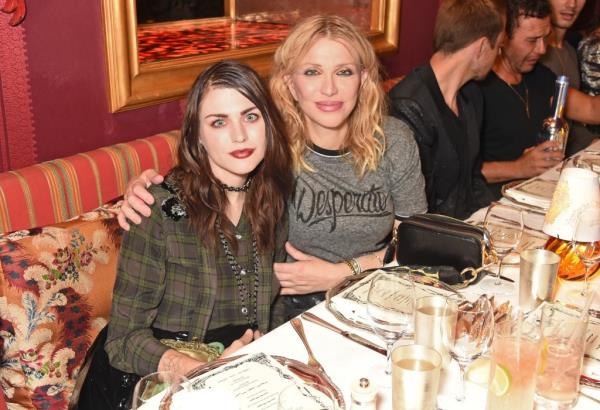Courtney Love and Frances Bean Cobain seated at a resaurant