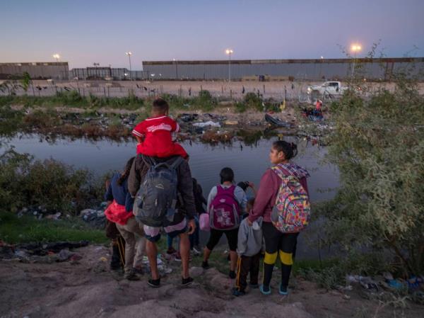 Migrants getting on a bus in Eagle Pass, Texas that will transport them to New York on September 22, 2023.