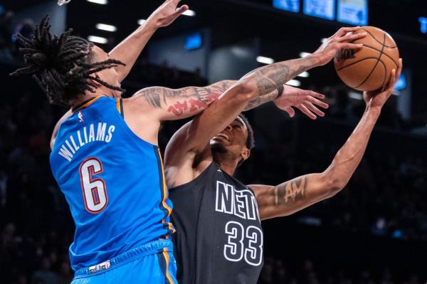 Nic Claxton #33 of the Brooklyn Nets goes up for a shot as Jaylin Williams #6 of the Oklahoma City Thunder defends in the first half at Barclays Center