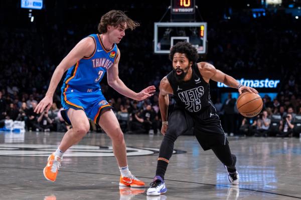 Spencer Dinwiddie #26 of the Brooklyn Nets drives down court as Josh Giddey #3 of the Oklahoma City Thunder defends in the first half at Barclays Center