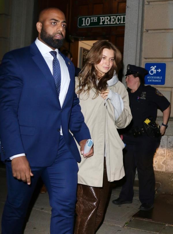 Grace Jabbari leaves the 10th Precinct in Manhattan Wednesday night after turning herself in wher<em></em>e she was charged with assault and criminal mischief.