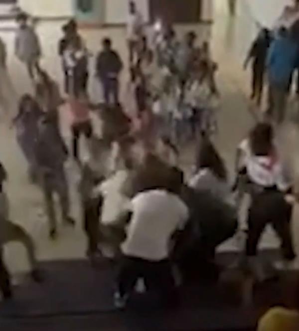 The brawl happened during a kindergarten graduation ceremony which lead to the arrest of three adults.