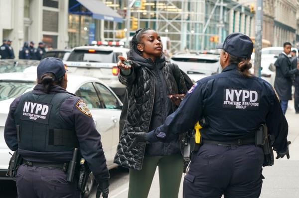 A woman standing in front of NYPD officers during a crowd co<em></em>ntrol operation at Versace sample sale on 125 W 18st., Manhattan