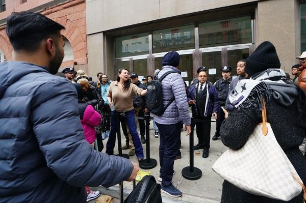 NYPD officers co<em></em>ntrolling a crowd of people outside the Versace sample sale at 125 W 18st., Manhattan, with celebrity Yu Fengtong present.