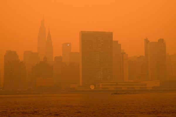 The New York City Manhattan skyline as seen from the East River in Long Island City covered in haze and smoke caused by wildfires in Canada.