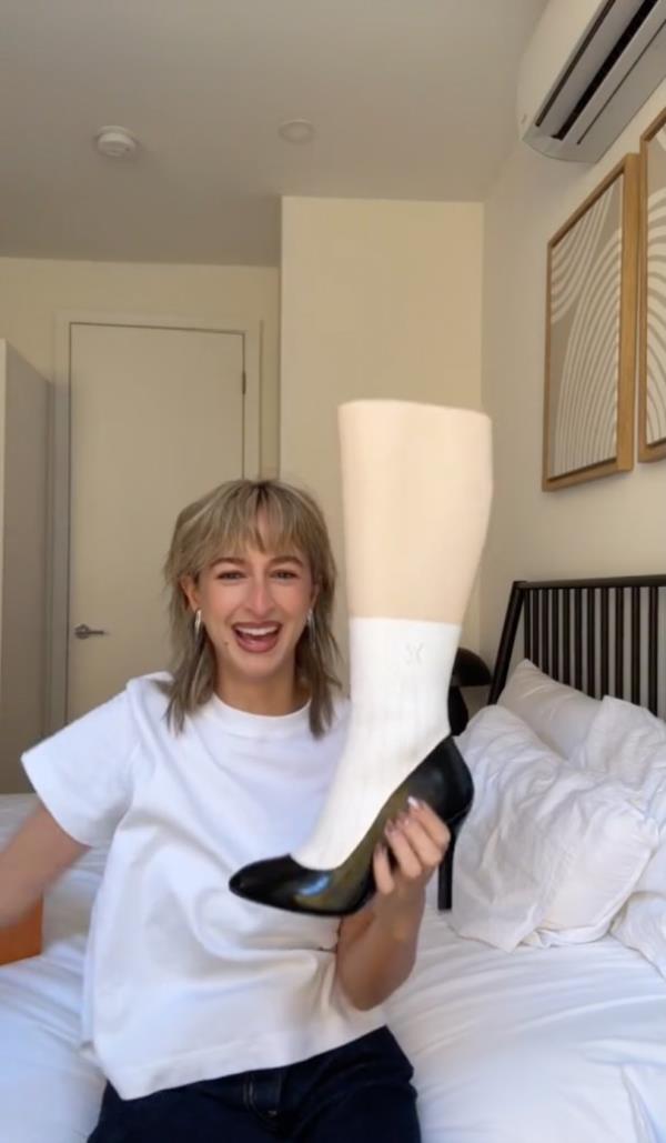 Isabelle Allain holding LV shoe