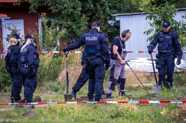 Police officers and archaeologists search for evidence of the theft of a gold treasure from Upper Bavaria on a private property in Plate, Germany.