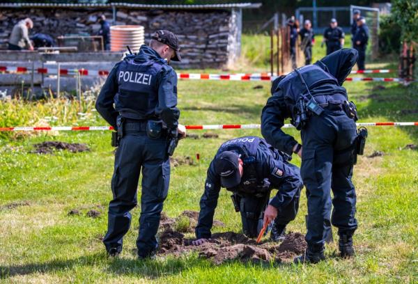 Police officers and archaeologists search for evidence of the theft of a gold treasure from Upper Bavaria on a private property in Plate, Germany.