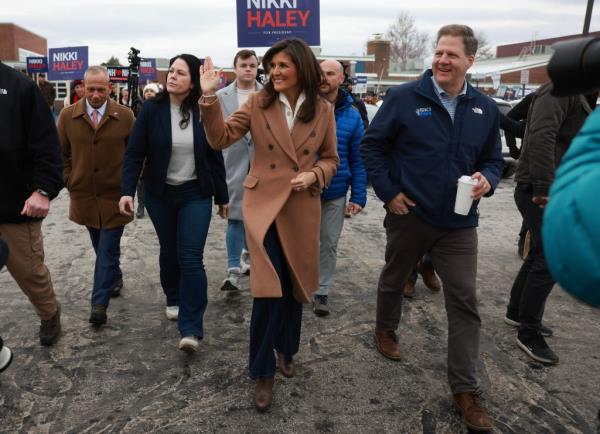 Republican presidential candidate and former U.N. Ambassador Nikki Haley with NH Gov. Chris Sununu as they visit a polling location at Winnacunnet High School to greet voters on Tuesday, Jan. 23, 2024, in Hampton, NH. 