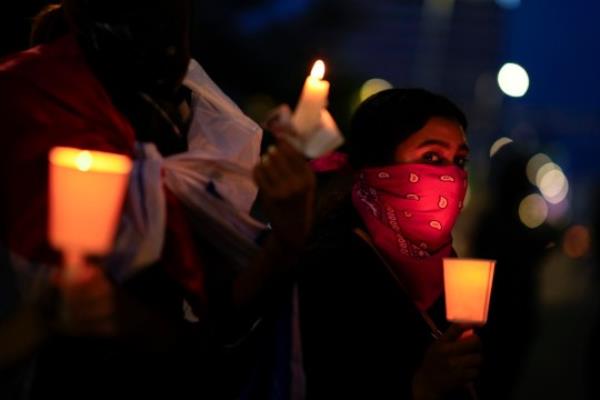 A woman holds a candle during a vigil at a protest against a recently approved mining co<em></em>ntract between the government and Canadian mining company First Quantum in Panama City, Wednesday, Nov. 8, 2023. Two people died on Tuesday while participating in a third week of protests against a co<em></em>ntroversial government mining co<em></em>ntract in Panama, officials ////con<em></em>firm/i/i/i/ied. (AP Photo/Arnulfo Franco)