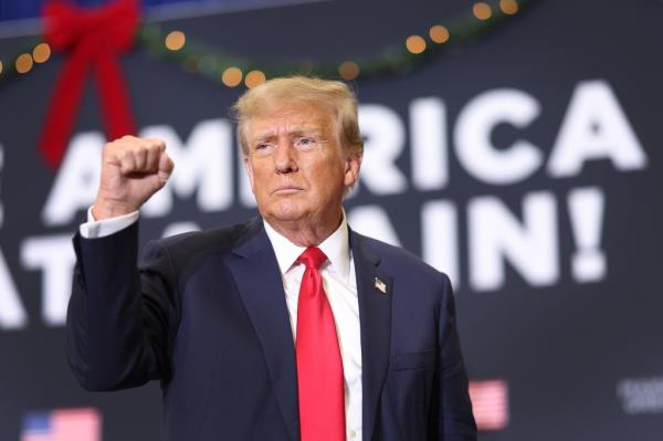 Republican presidential candidate and former U.S. President Do<em></em>nald Trump gestures as he wraps up a campaign event on December 19, 2023 in Waterloo, Iowa.