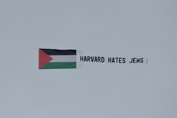 Students fly a banner over Harvard's campus on Thursday.