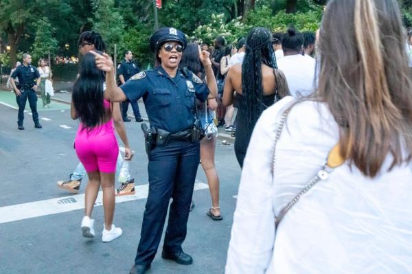 Police officer directing a crowd in the street