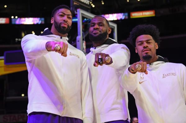 Anthony Davis, LeBron James and Quinn Cook pose for a photo as they get their 2019-20 NBA Champio<em></em>nship rings during a ceremony on December 22, 2020 at STAPLES Center in Los Angeles, California. 