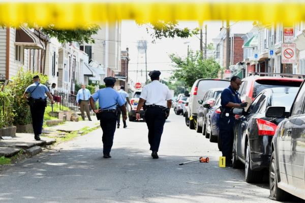 Police canvas the scene of Mo<em></em>nday night's deadly shooting in Philadelphia's Kingsessing neighborhood. 