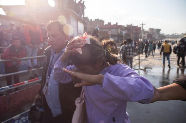 An injured girl is being taken to the hospital after the clashes between Nepal Police perso<em></em>nnel and pro-mo<em></em>narchy supporters during a demo<em></em>nstration against the Nepal's Federal Democratic Republic system at Balkhu. 