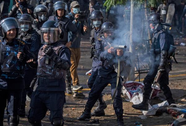 A policeman fires tear gas towards protesters during a rally demanding a restoration of Nepal's mo<em></em>narchy in Kathmandu, Nepal on Nov. 23, 2023.