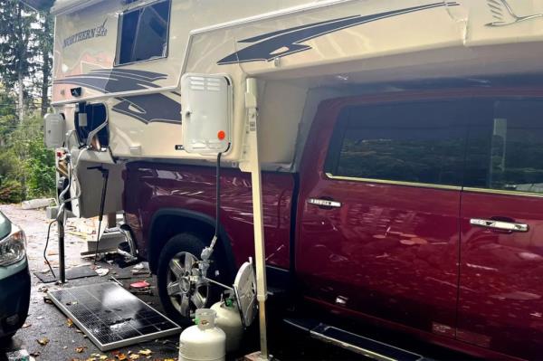 Exterior view of the Hamlin family's camper after the explosion, showing visible fractures at the front of the camper and the tanks that caused the explosion.