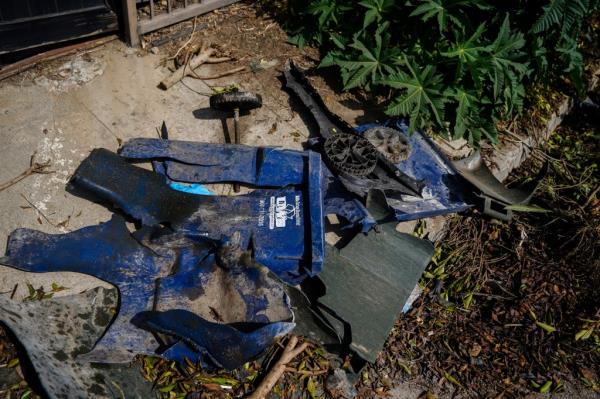 The remnants of a garbage can lay on the ground along the highway on Oct. 18, following the deadly crash.