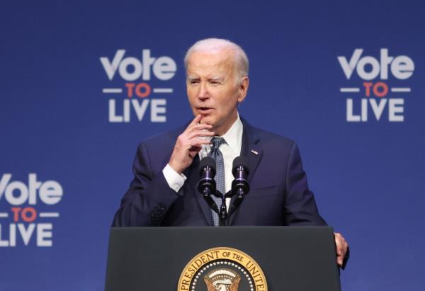 biden at a podium at a microphone