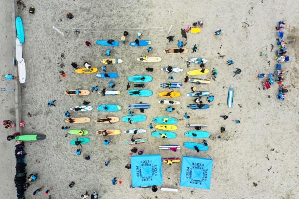 Drone view of beginner surfers practicing on the shore during the Juneteenth and Internatio<em></em>nal Surf Day celebration by Paddle for Peace at La Jolla shore, San Diego.