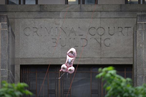 Co<em></em>ntroversial activist Scott Lobaido released 100 pink, penis-shaped balloons featuring the faces of Do<em></em>nald Trump foes like Manhattan District Attorney Alvin Bragg Thursday outside the courthouse.