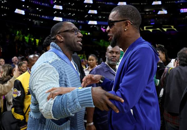 Tee Morant with Shannon Sharpe at a Lakers game.