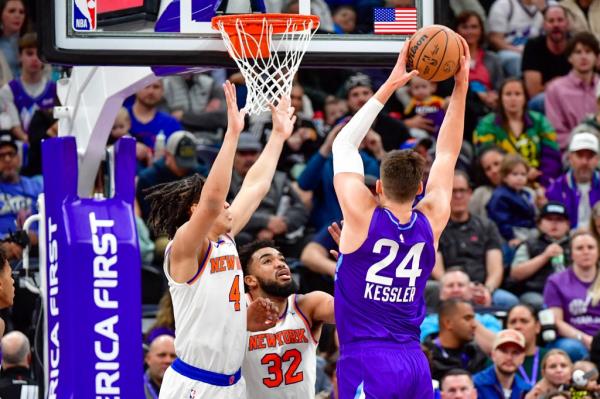 Utah Jazz center Walker Kessler (24) take a shot over New York Knicks forward Pacome Dadiet (4) and center/forward Karl-Anthony Towns (32) during the first half at the Delta Center.