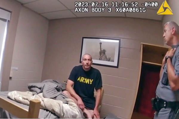 An Army Reservist, Robert Card, being interviewed by New York State Police sitting on a bed at Camp Smith in Cortlandt, in this body cam image.