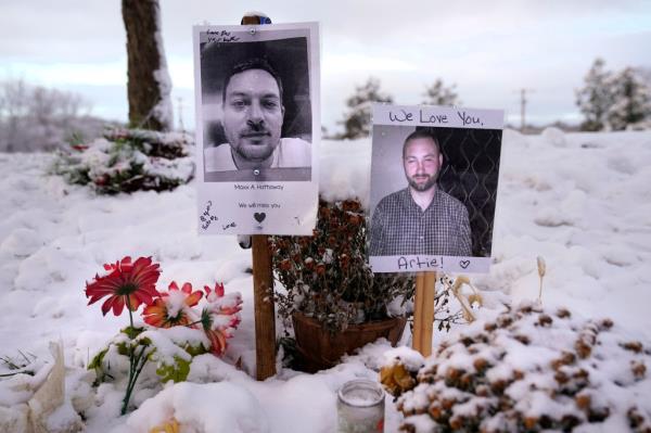 Pictures of two victims on a makeshift memorial with flowers in the snow, referencing the 2023 mass shooting in Lewiston by Robert Card.