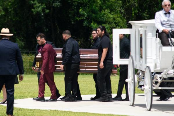 Family members taking Nungaray's casket out of the carriage.
