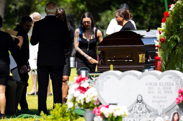 Alexis Nungaray walking back to the tent after releasing doves during Jocelyn's funeral.