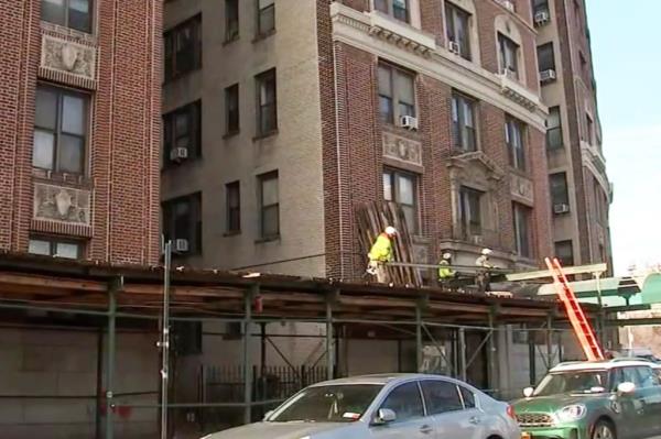 Workers removing the scaffolding at 409 Edgecombe Ave. in Harlem.