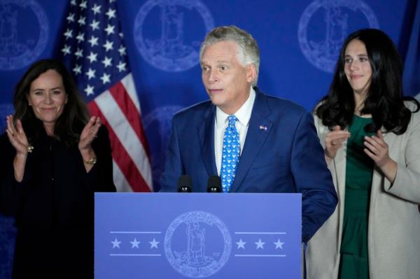 Terry McAuliffe speaking at his election night event, standing behind a podium in a suit in McLean, Virginia on November 2nd, 2021.